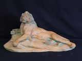 sculpture of a lion on a rock on a black background