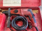 a red tool box with a hammer and other tools in it