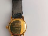 an image of a close up of a wrist watch on a white surface
