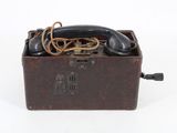 an old fashioned telephone sitting in a box on a white surface