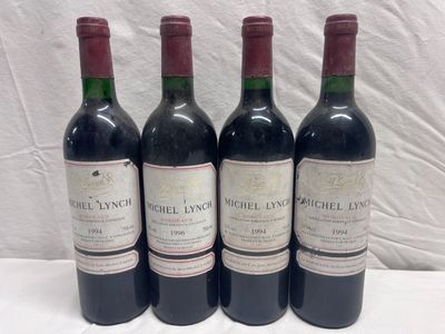 four bottles of wine are lined up on a table