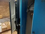several blue lockers in a room with boxes and boxes on the floor