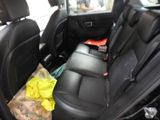 the back seats of a car with a bunch of items in it