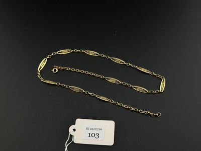 a close up of a gold chain with a tag attached to it
