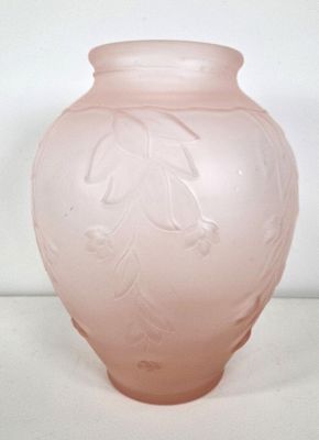 a pink vase sitting on a table with a white background