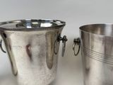 pair of silver ice buckets with handles on a white background