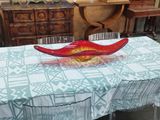 a glass bowl sitting on a table with a blue and white tablecloth