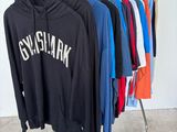 a rack with a bunch of shirts hanging on it