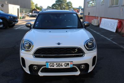 a white mini cooper parked in a parking lot