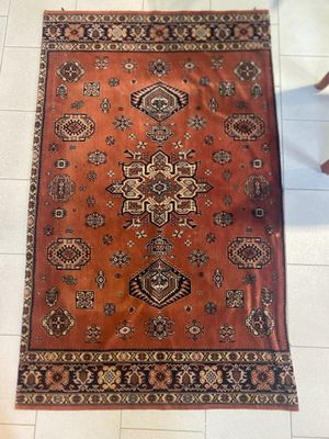 rug on the floor in a room with a chair and a table