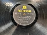 an old record with a label on it sitting on top of a table