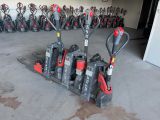 a lot of red and black skis in a garage