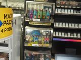 a vending machine in a store next to a laptop