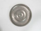 a metal object that is sitting on a white surface