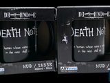 two black coffee mugs with death note on them in a box