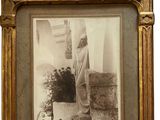 an old photo of a man standing in front of a building
