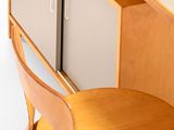 a small desk with a chair next to it