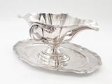 a silver plate with a silver flower on it