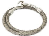 a close up of a leather bracelet with a metal clasp on a white background