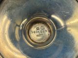 a close up of a silver vase with a number on it