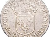 a close up of a silver coin with a crown on it