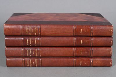 a stack of four books sitting on top of each other on a table