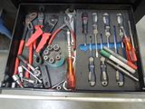 many tools in a tool box on the floor
