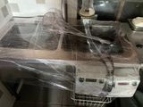 a picture of a kitchen with a sink and a counter covered in plastic