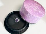 a box with a ring inside of it on a table