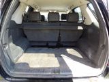 the back of a car with its trunk open and the seats folded down