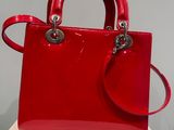 a red handbag sitting on top of a white table
