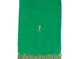 a green scarf with a gold deer on it