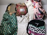 a lot of clothes that are sitting on a table