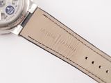 a close up of a watch on a white surface