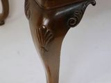 a wooden table with a brown top on a white floor