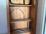 a wooden cabinet with a mirror on top of it