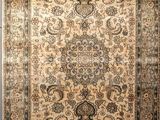 a beige and black rug on a wooden floor