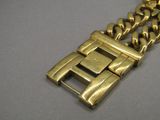 an image of a close up of a gold bracelet on a table