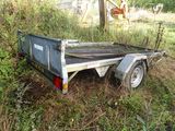 a trailer that is sitting in the middle of the grass
