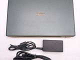 a laptop computer that is sitting on a table with a charger