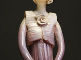statue of a woman in a purple dress with a flower in her hair
