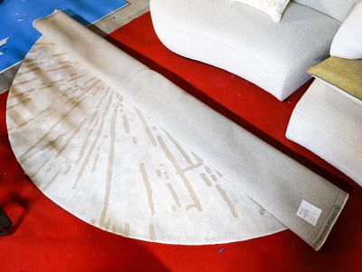 a red carpet with a white couch and pillows on it