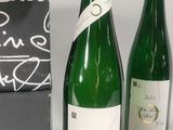 three bottles of wine sitting next to each other on a table