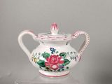 a white tea pot with a pink rose design on it