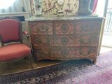 a dresser with a mirror and a chair in a room