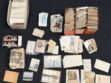 a lot of cards and a box of books on a table