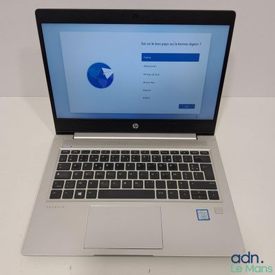 an open laptop computer sitting on top of a white table