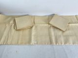 three napkins on a table with a white table cloth