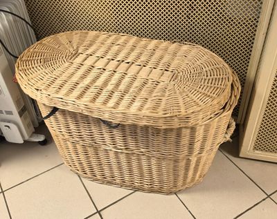 a wicker basket sitting on the floor next to a radiator