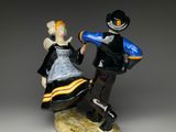 figurine of a man and a woman dancing on a rock